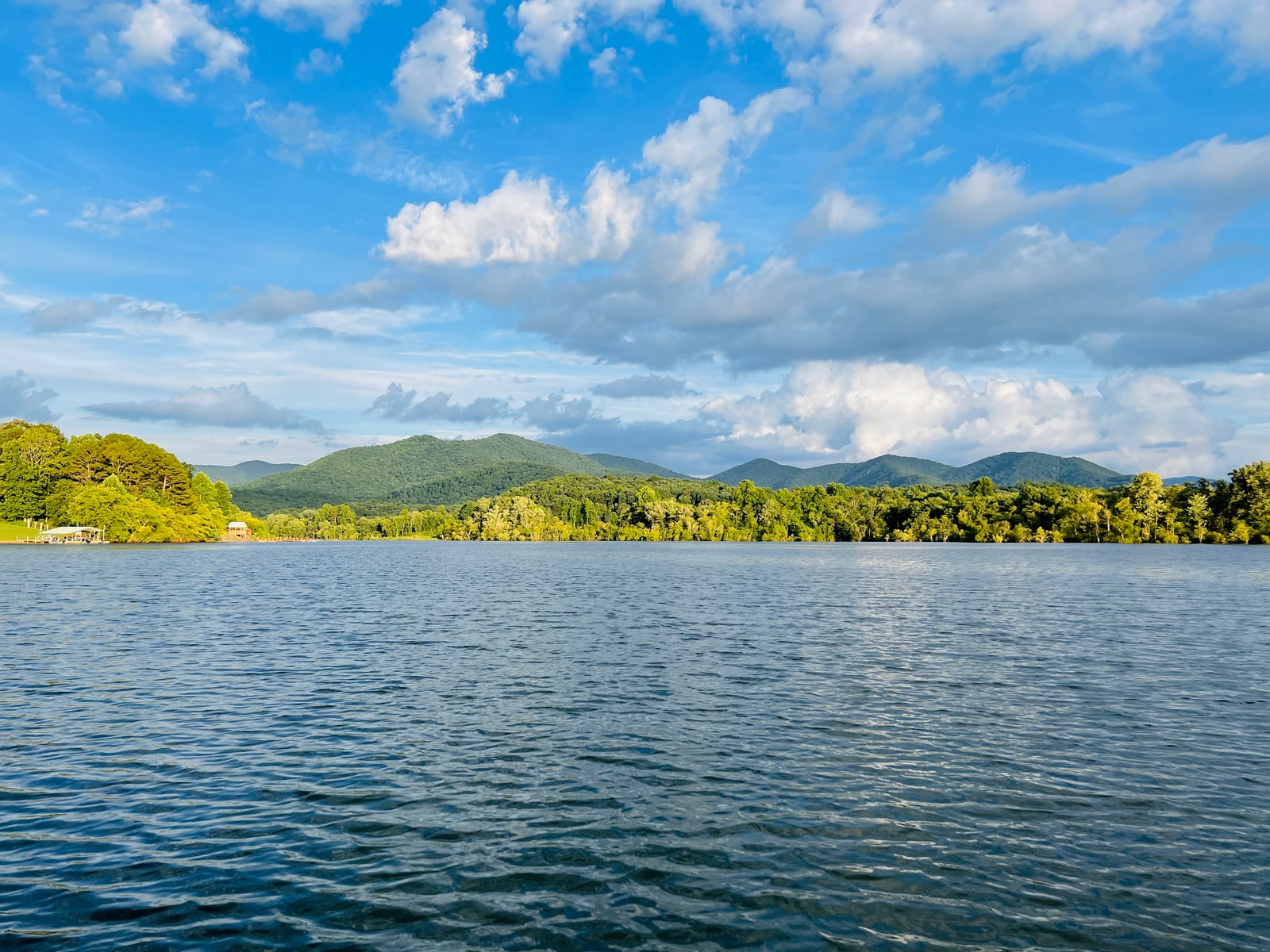 Lake Chatuge water with a mountain backdrop under blue skies