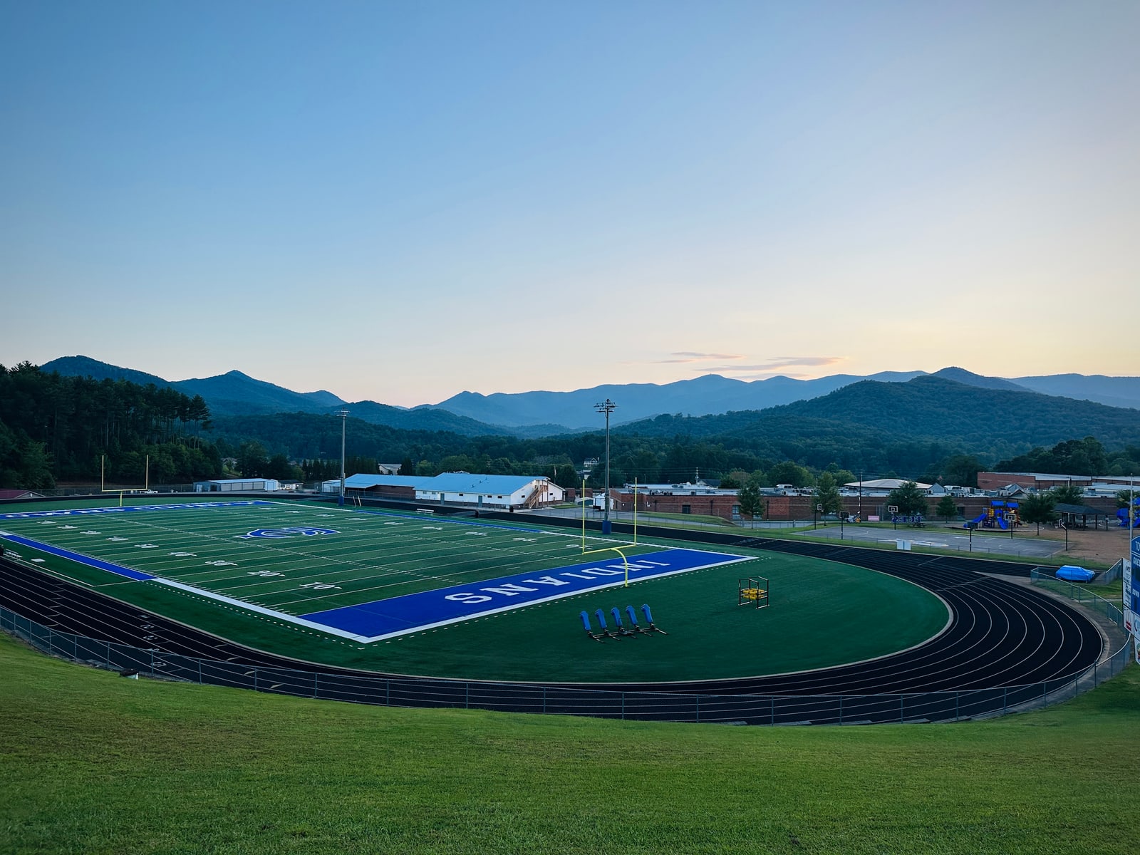 Towns County athletic field framed by mountain ridges at dusk