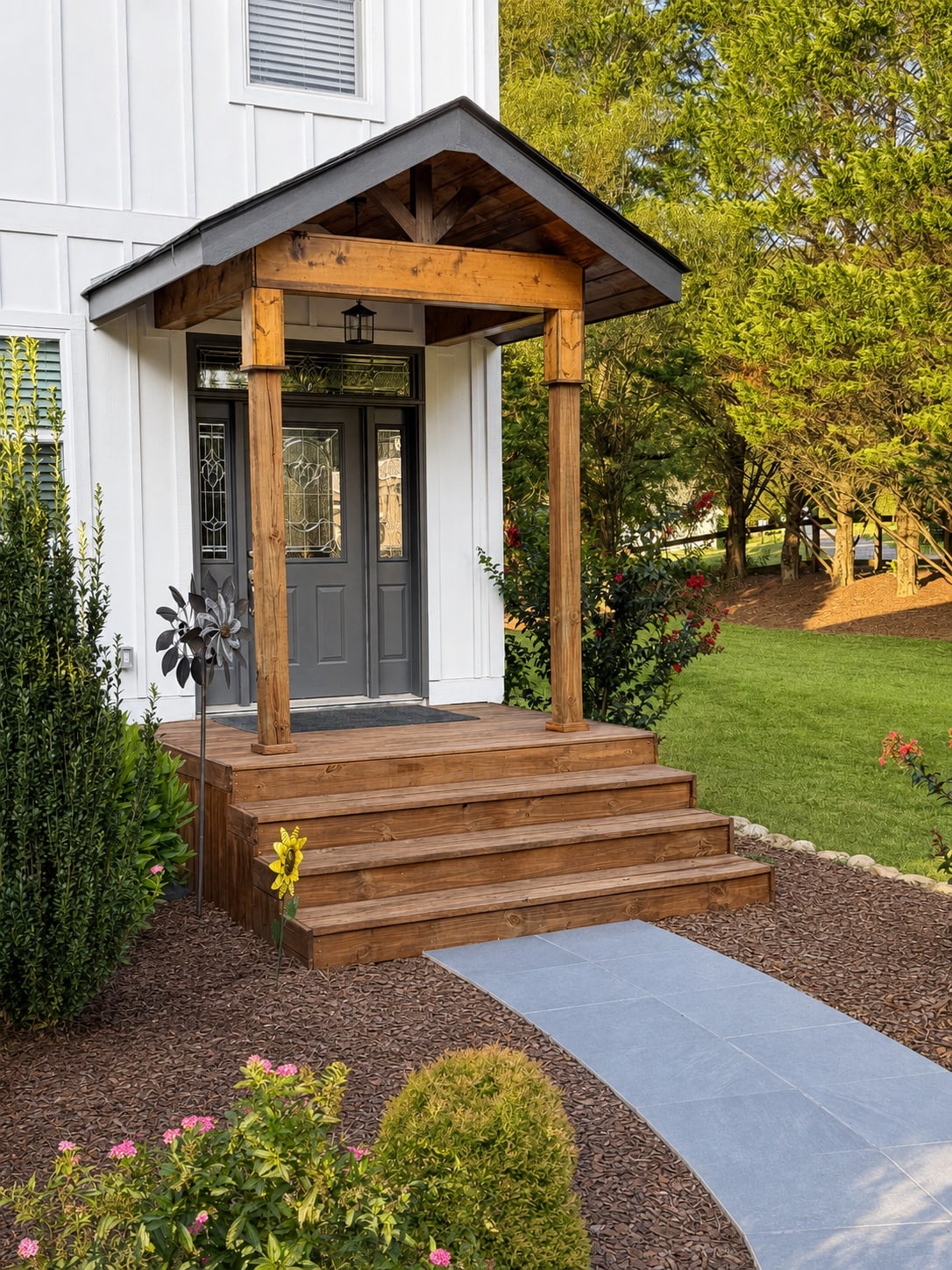 Timber-framed front portico and walkway leading to the entrance