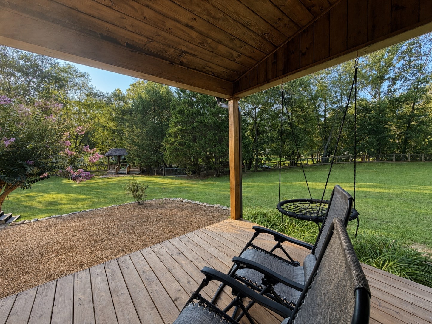 Porch swing and seating looking out over the open yard