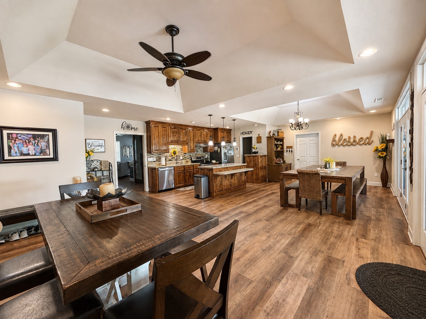 Open kitchen and dining area with wood floors and vaulted ceiling