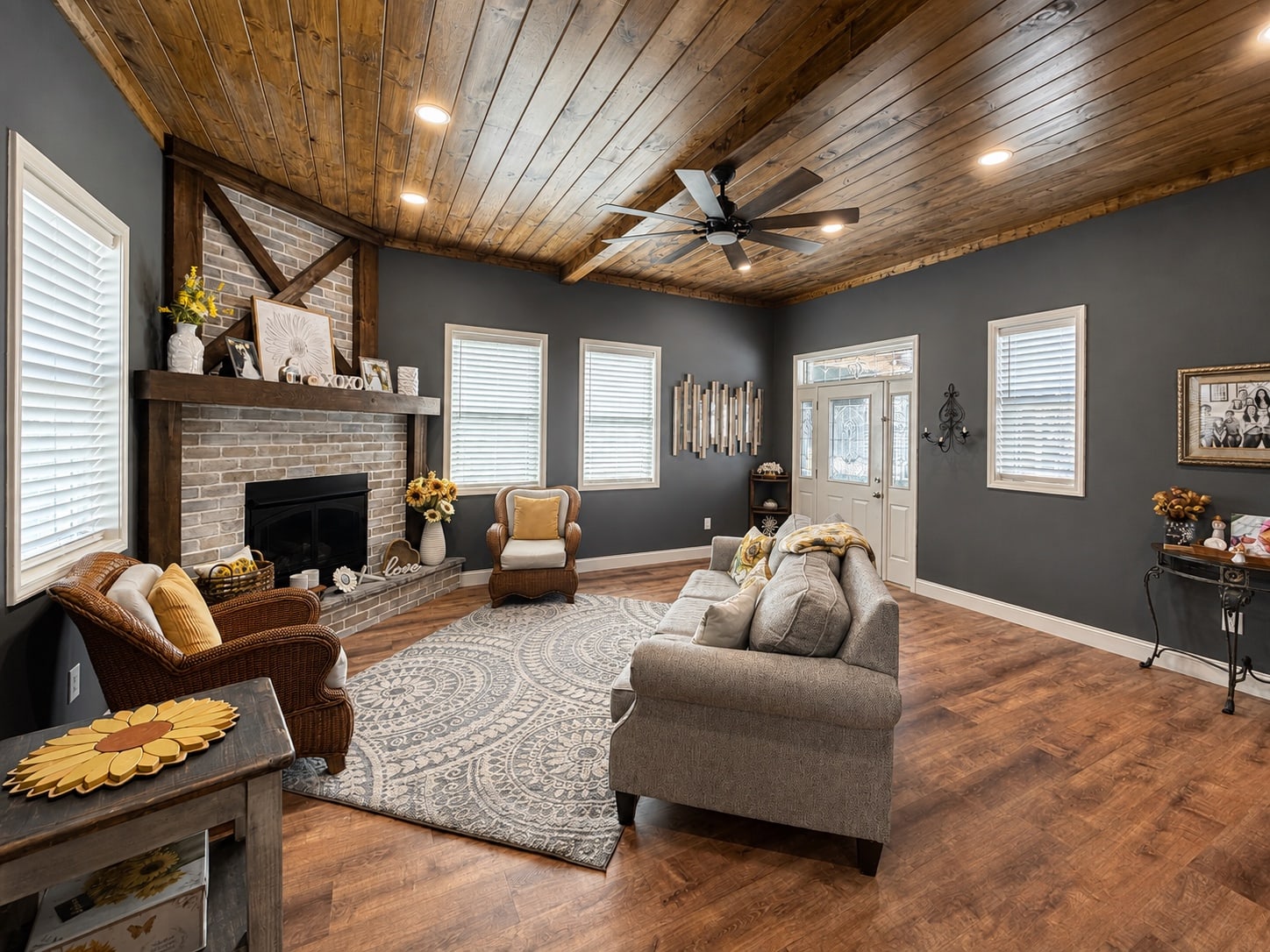Living room with brick fireplace, heavy timber mantel, and wood ceiling
