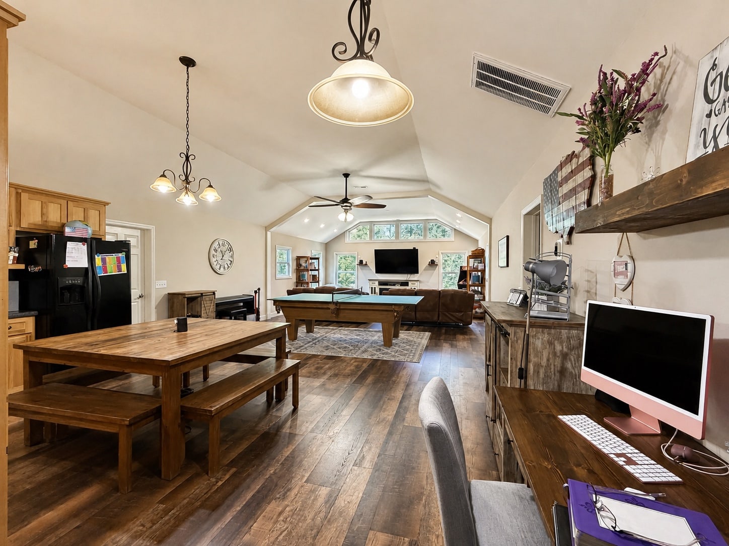 Large recreation room with billiards table, table seating, and media area