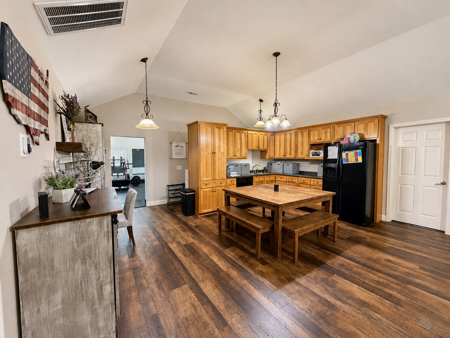 Secondary kitchen and dining workspace with wood cabinets and counters