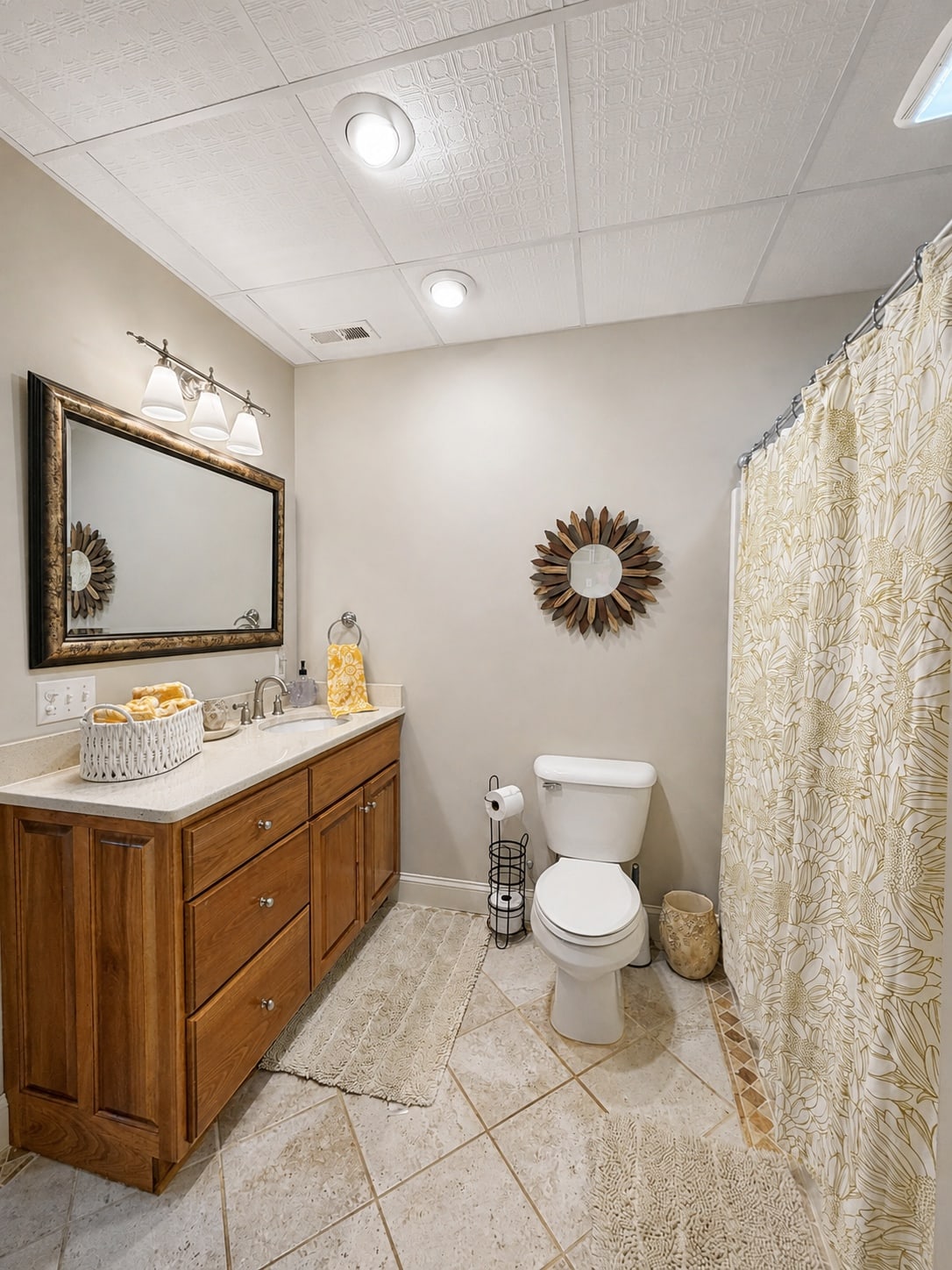 Full bathroom with wood vanity, tiled floor, and tub-shower combination
