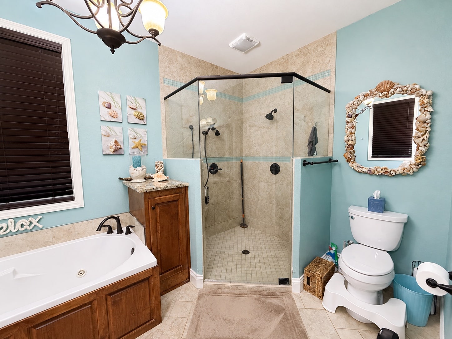 Primary bathroom with glass-enclosed walk-in shower and jetted tub
